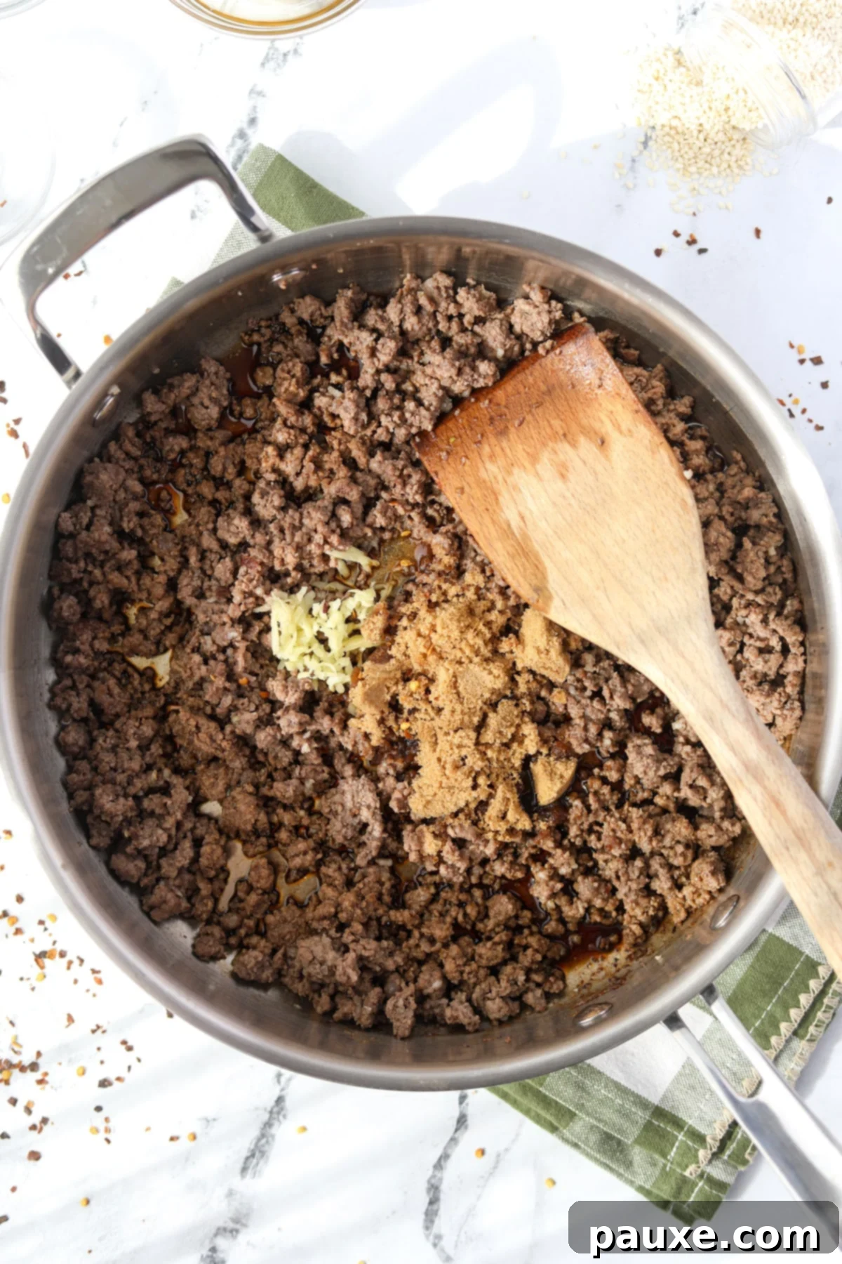 Authentic Korean Marinated Beef 7 Stirring ginger, soy sauce, and brown sugar into a skillet of ground beef to create the flavorful Korean sauce.