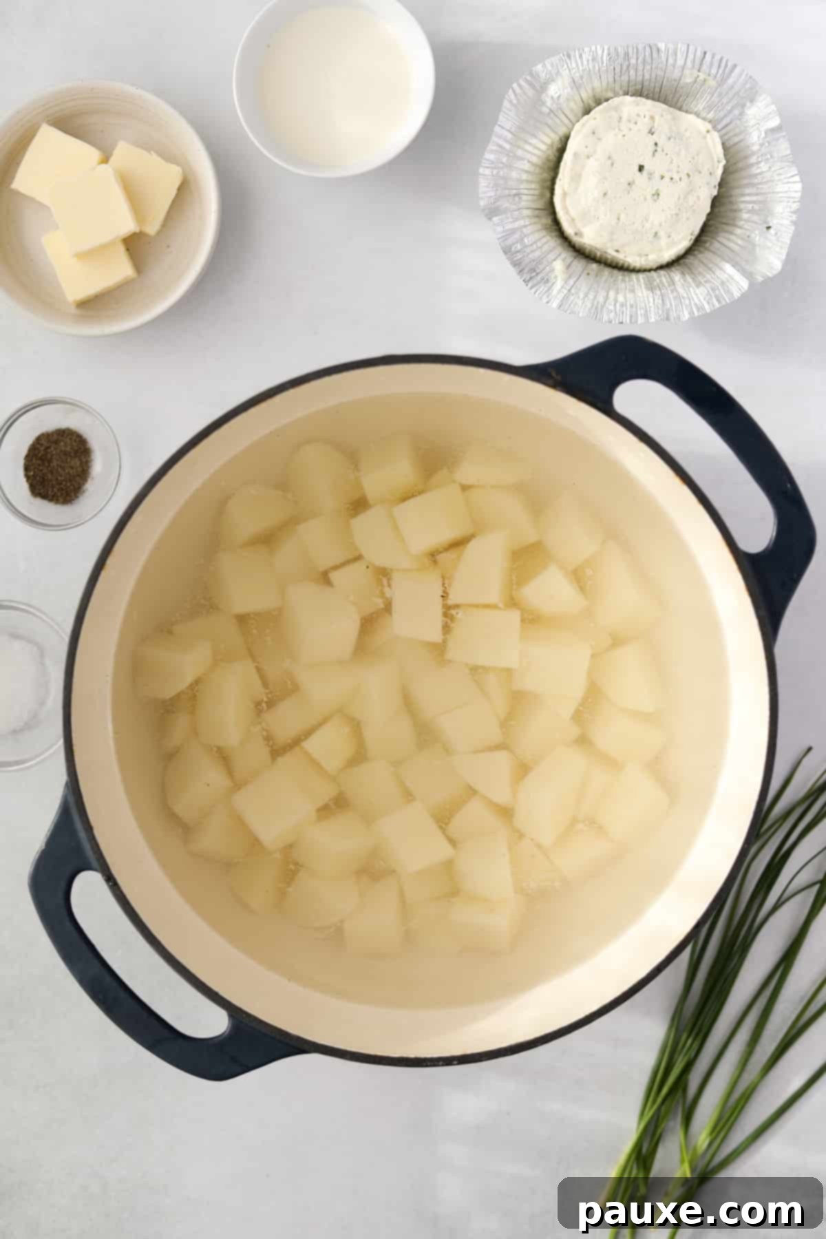 Creamy Garlic Herb Boursin Mash 4 A dutch oven filled with cubed potatoes.