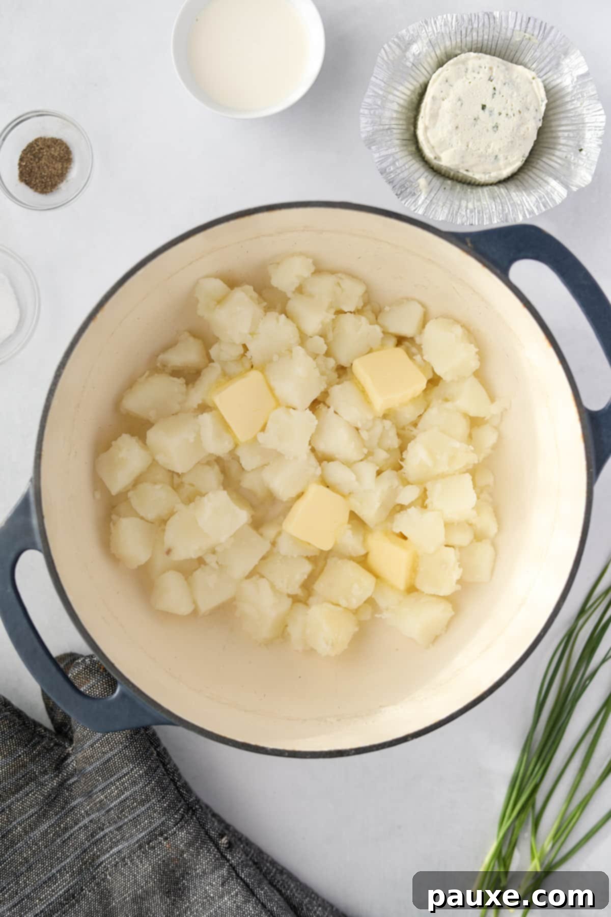 Creamy Garlic Herb Boursin Mash 5 Cooked cubed potatoes with butter in a large pot/