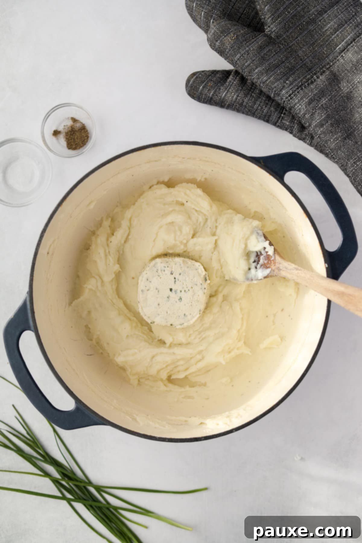Creamy Garlic Herb Boursin Mash 8 A dutch oven filled with mashed potatoes and a round of boursin cheese.
