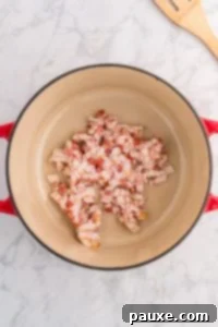 Rancher's Hearty Stew 15 A Dutch Oven filled with raw bacon pieces before cooking.