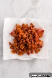 Rancher's Hearty Stew 16 Cooked and crumbled bacon pieces resting on a paper towel-lined plate.