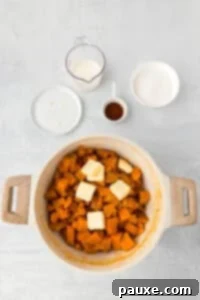 Pecan Streusel Sweet Potato Bake 17 A pot filled with cooked sweet potatoes and a few pats of butter.