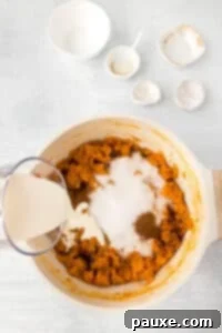 Pecan Streusel Sweet Potato Bake 18 A pot of mashed sweet potatoes with sugar, cinnamon, and cream added.