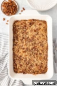 Pecan Streusel Sweet Potato Bake 23 Sweet potato casserole in a large white baking dish, topped with pecans.