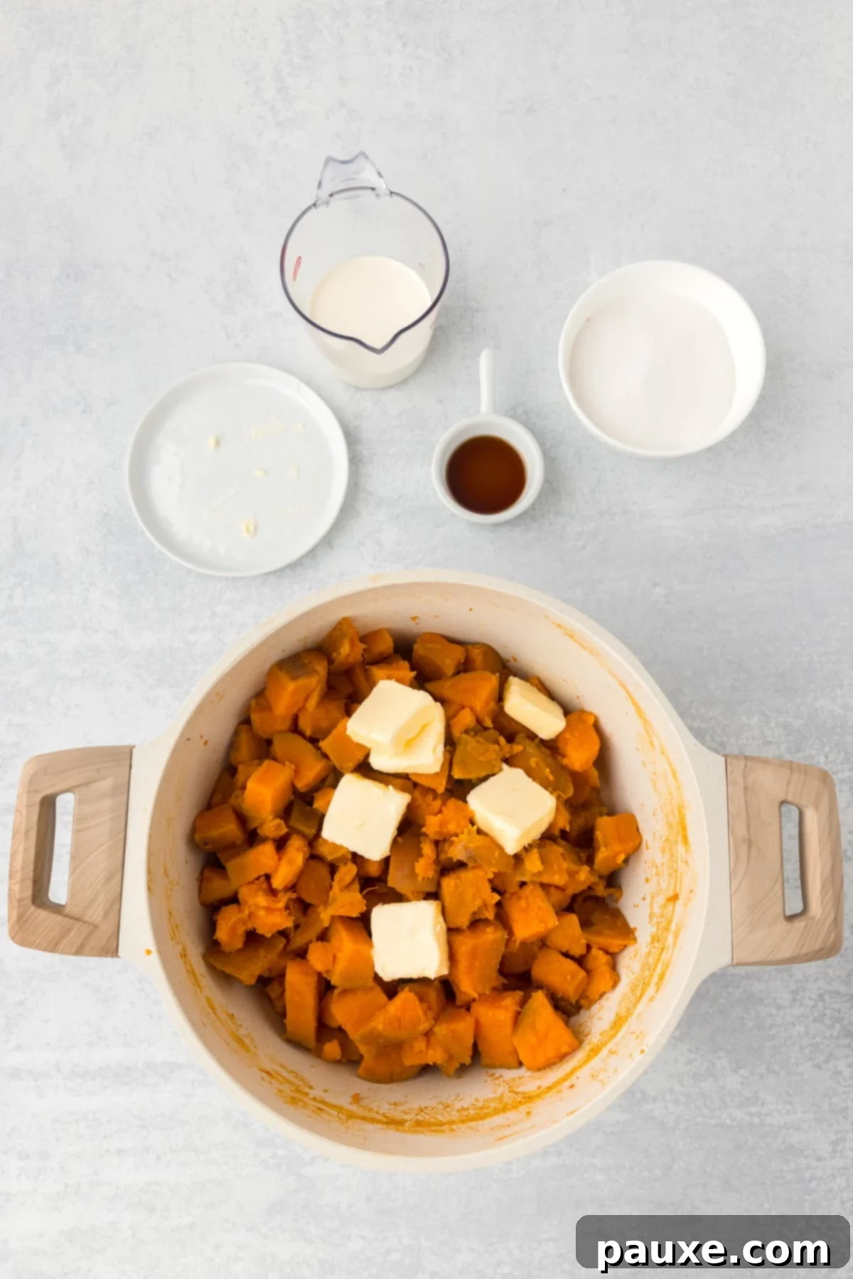 Pecan Streusel Sweet Potato Bake 5 A pot filled with cooked sweet potatoes and a few pats of butter.