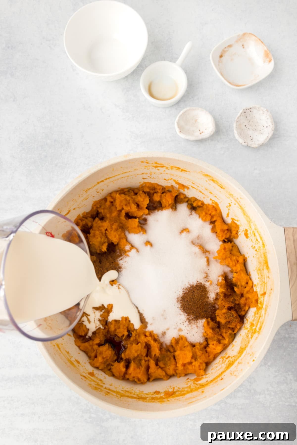 Pecan Streusel Sweet Potato Bake 6 A pot of mashed sweet potatoes with sugar, cinnamon, and cream added.