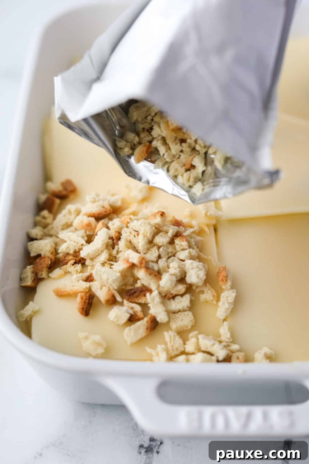 Alpine Chicken Comfort Bake 9 Sprinkling dry stuffing mix evenly over the Swiss cheese layer of the casserole.