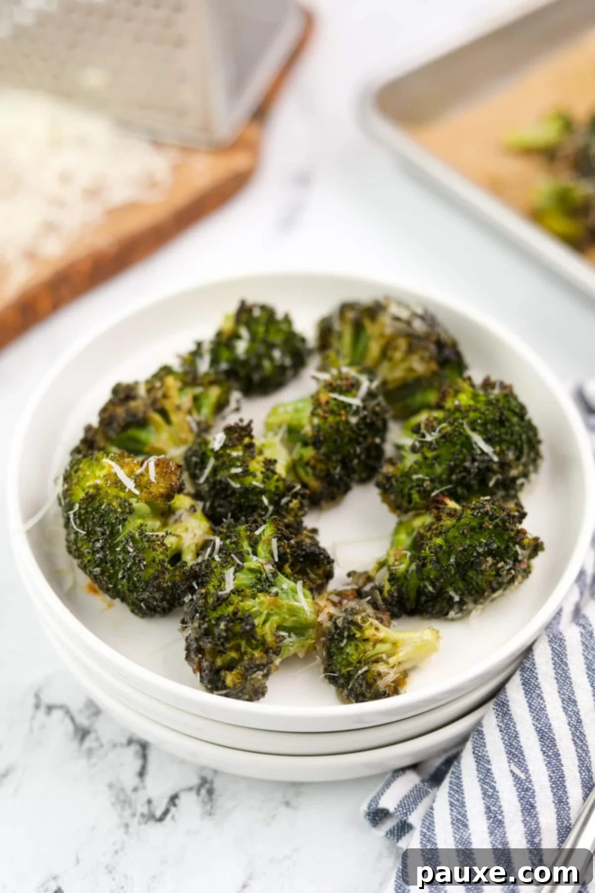 Zesty Ranch Roasted Broccoli 11 A small, elegant white plate holding a generous serving of perfectly roasted ranch broccoli, highlighting its appealing texture and vibrant color.