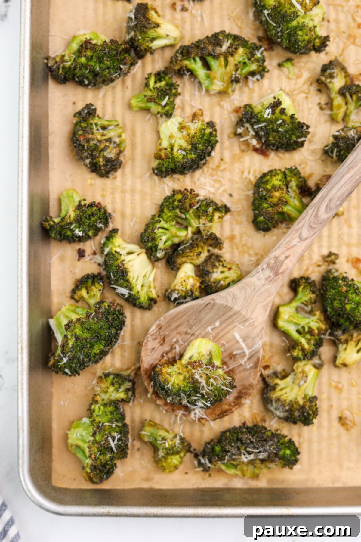 Zesty Ranch Roasted Broccoli 12 A baking sheet filled with perfectly roasted broccoli florets, beautifully browned and seasoned, with a light dusting of parmesan cheese.
