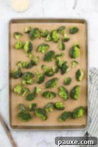 Zesty Ranch Roasted Broccoli 17 Broccoli florets spread onto a lined baking dish.