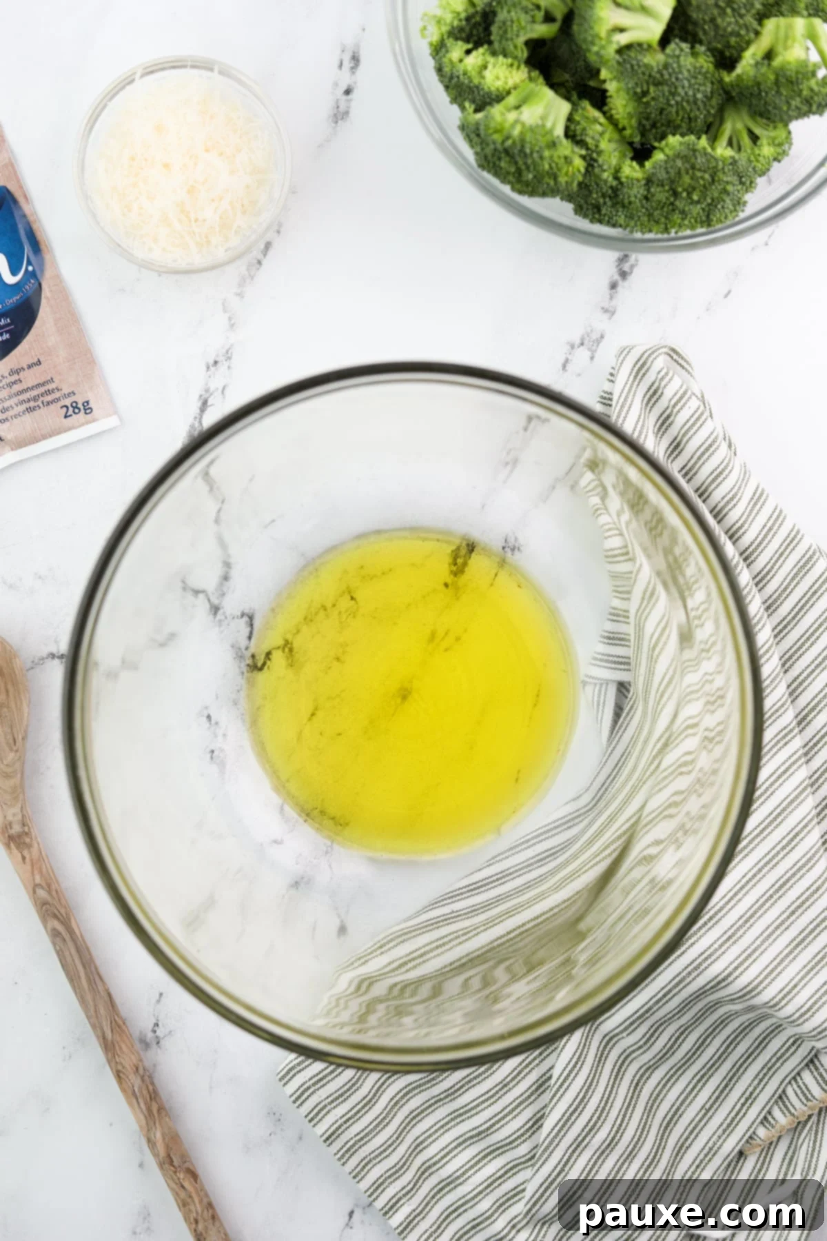 Zesty Ranch Roasted Broccoli 4 A glass bowl containing a generous amount of golden olive oil, ready for seasoning.