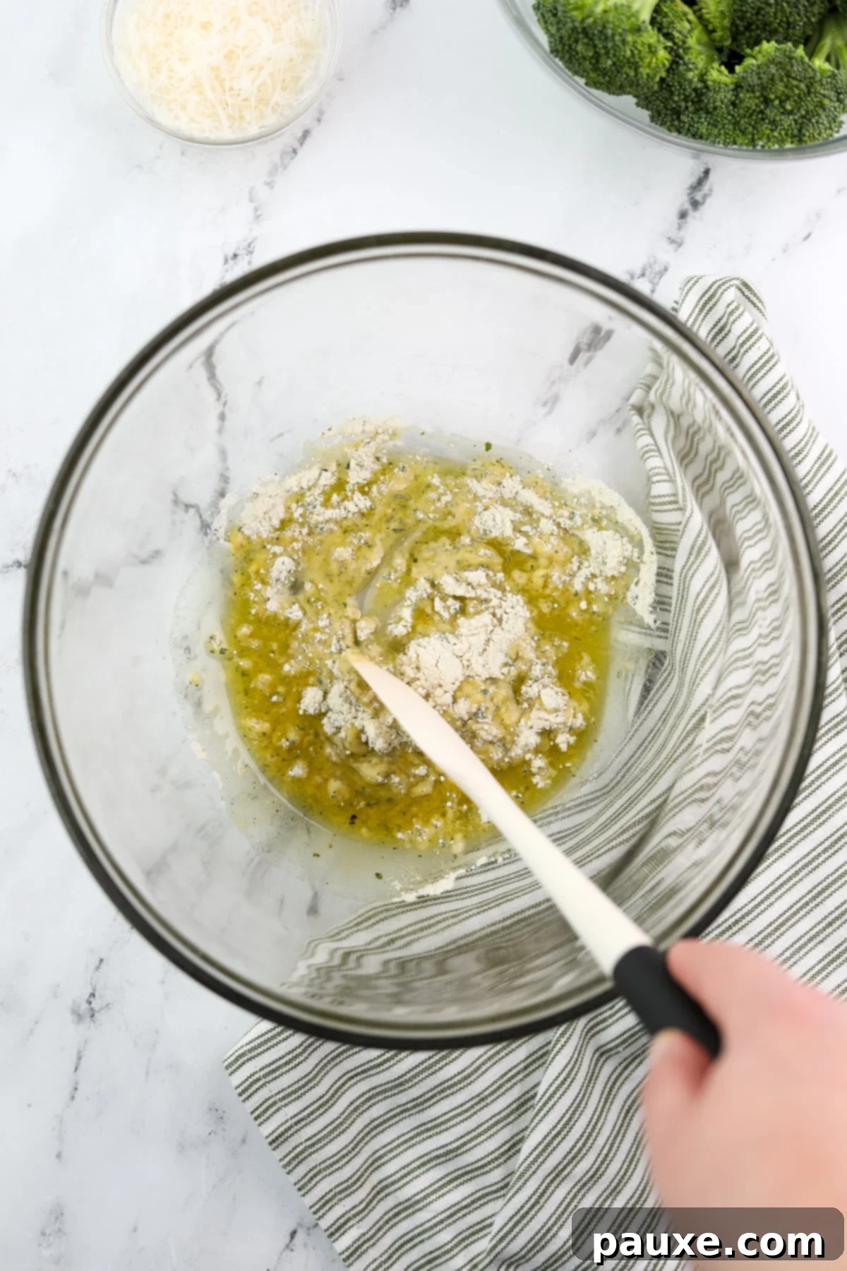 Zesty Ranch Roasted Broccoli 6 A spoon actively stirring the ranch seasoning and olive oil together in a bowl, creating a smooth, cohesive paste.