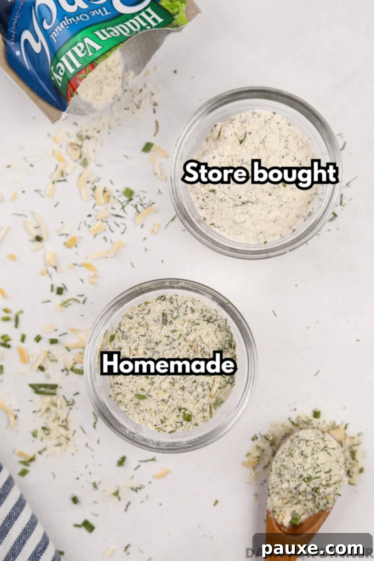 An overhead shot comparing two small bowls: one filled with the lighter, more textured homemade ranch seasoning, and the other with a finer, whiter store-bought version.