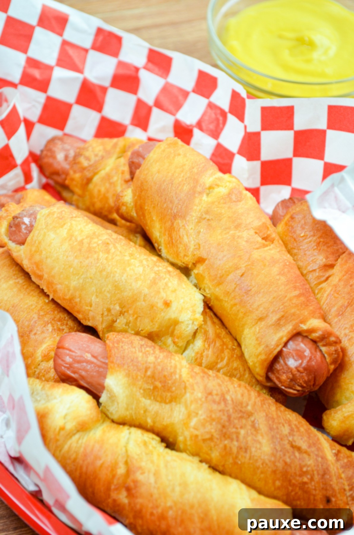 Air Fryer Pigs in a Crispy Blanket 8 A basket full of freshly cooked, golden air fryer pigs in a blanket, ready to eat.