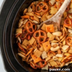 Effortless Slow Cooker Party Mix 13 A slow cooker or crock pot insert filled with lightly browned Chex Mix, ready to be served.