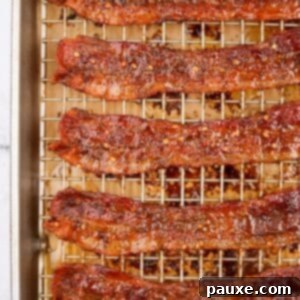 Decadent Glazed Bacon 12 A wire cooking rack filled with cooked bacon that's been candied with brown sugar and crushed chilies.