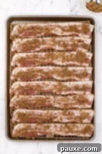 Decadent Glazed Bacon 15 A baking sheet filled with bacon that has been sprinkled with brown sugar.