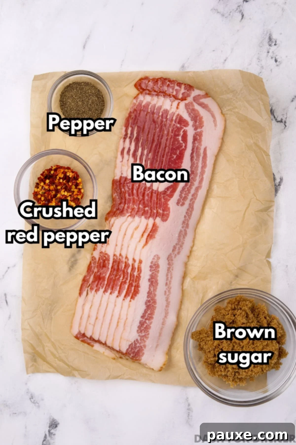 Decadent Glazed Bacon 3 A top-down view of the four main ingredients for spicy candied bacon: raw bacon strips, a bowl of brown sugar, a pile of crushed red pepper flakes, and whole black peppercorns.