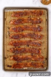Decadent Glazed Bacon 17 A baking sheet filled with cooked bacon that's crispy and coated with brown sugar.