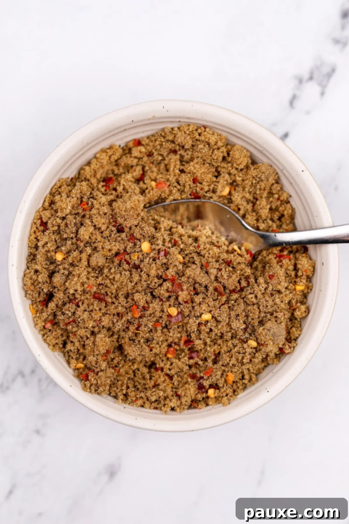 Decadent Glazed Bacon 5 A small bowl with the brown sugar, crushed chile flakes, and black pepper mixture stirred until well combined.