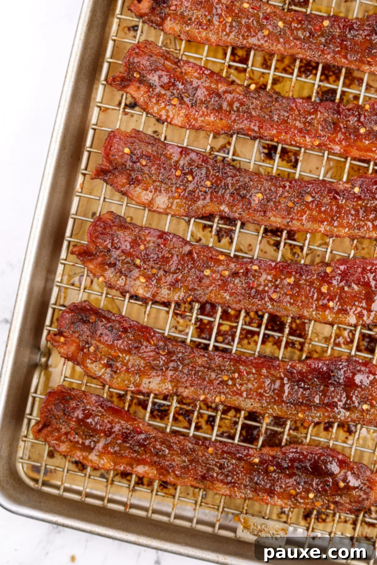 Decadent Glazed Bacon 10 Perfectly crispy and glazed Billionaire Bacon, arranged appealingly on a wire rack.
