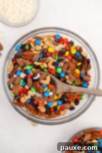 Trailblazer's Blend 15 A large bowl filled with trail mix, including nuts and M&M's candies.