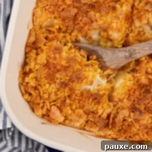 Gluten-Free Cheesy Hash Brown Casserole 18 A wooden spoon scooping from a baking dish of hash brown casserole.