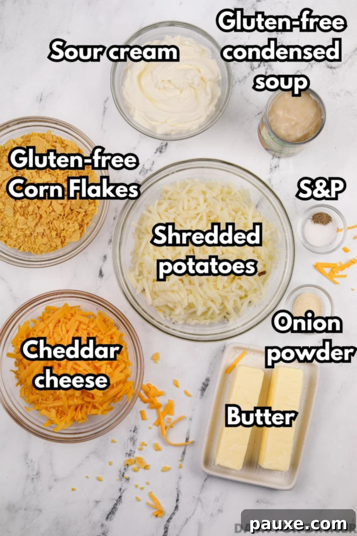 Gluten-Free Cheesy Hash Brown Casserole 3 A flat lay photograph showcasing all the gluten-free ingredients needed for funeral potatoes: thawed shredded hash browns, sour cream, gluten-free cream of chicken soup, butter sticks, cheddar cheese block, gluten-free corn flakes, and seasonings.