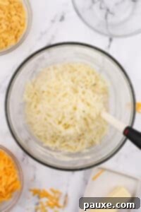 Gluten-Free Cheesy Hash Brown Casserole 21 A large bowl with shredded hash browns inside.