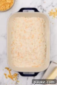 Gluten-Free Cheesy Hash Brown Casserole 23 Hash brown casserole spread into a baking dish.