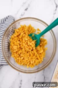 Gluten-Free Cheesy Hash Brown Casserole 25 Stirring corn flakes and melted butter in a bowl.