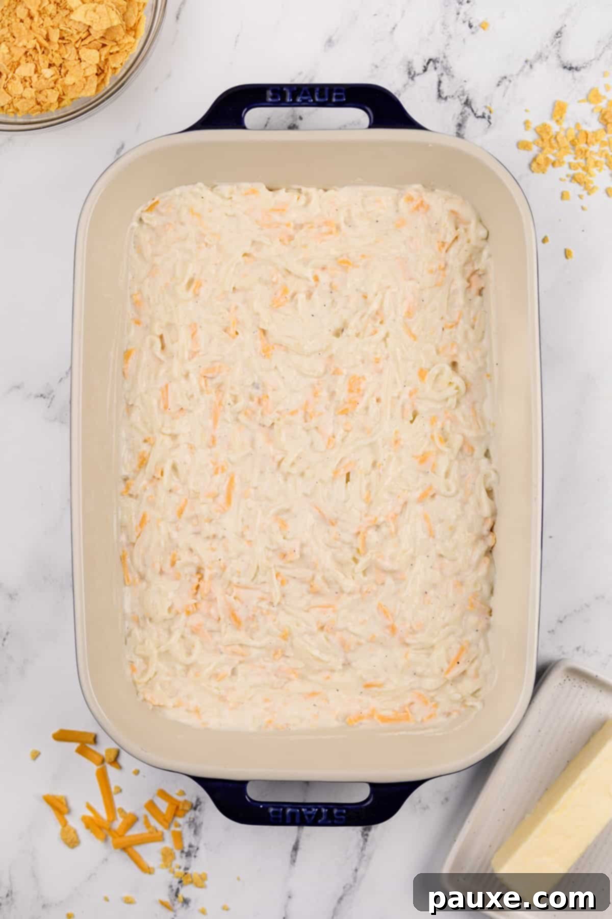 Gluten-Free Cheesy Hash Brown Casserole 9 The creamy, cheesy hash brown casserole mixture evenly spread into a greased 9x13 inch baking dish, ready for its crunchy topping and baking.