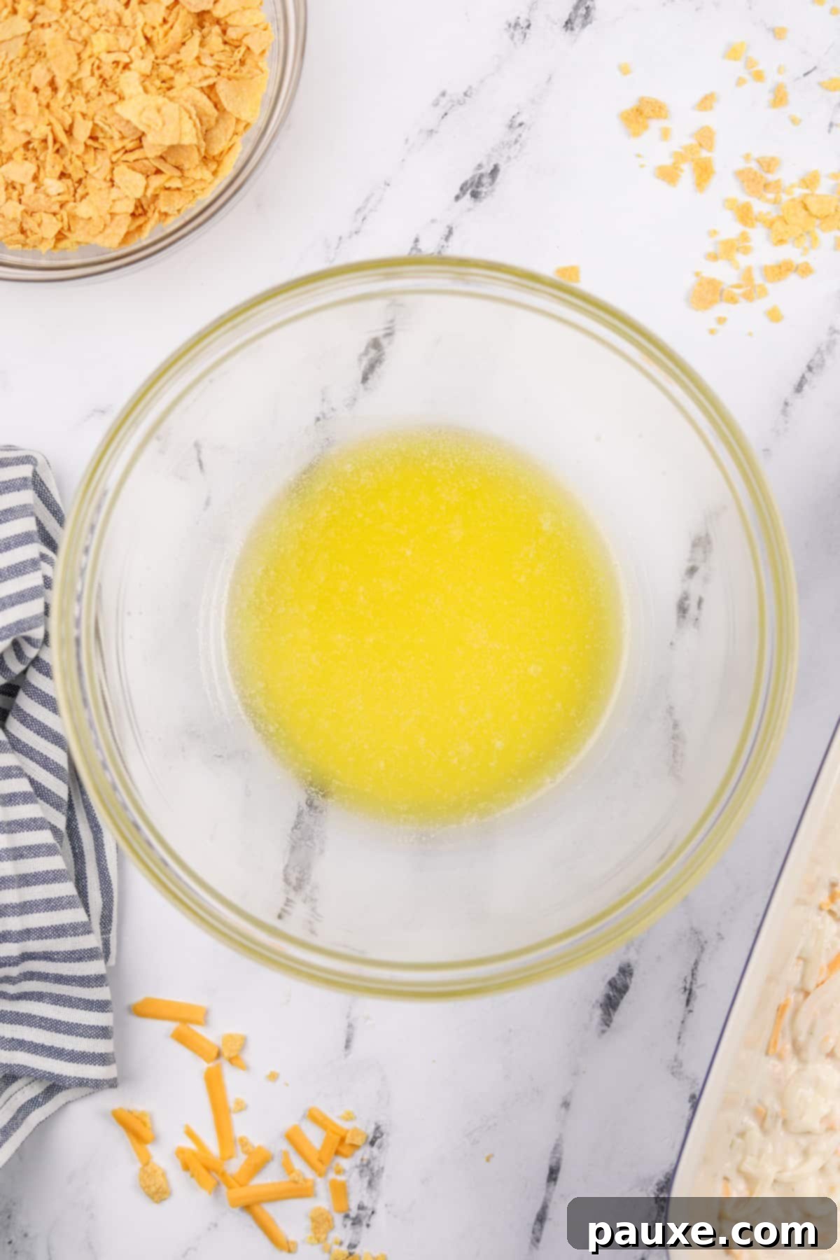 Gluten-Free Cheesy Hash Brown Casserole 10 A small, microwave-safe bowl containing perfectly melted butter, ready to be combined with the crushed gluten-free corn flakes for the casserole topping.