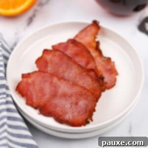 Easy Air Fryer Canadian Bacon 8 A small plate with four crispy slices of back bacon, ready to serve.