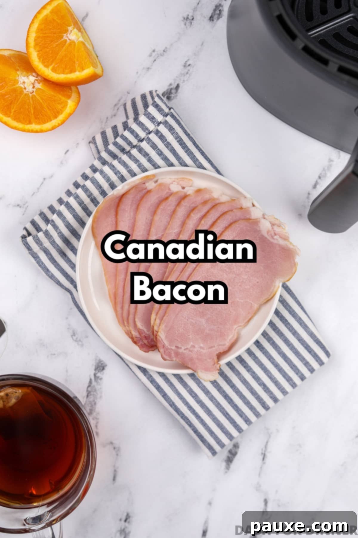 Easy Air Fryer Canadian Bacon 3 A plate displaying several slices of uncooked Canadian bacon, ready for the air fryer.