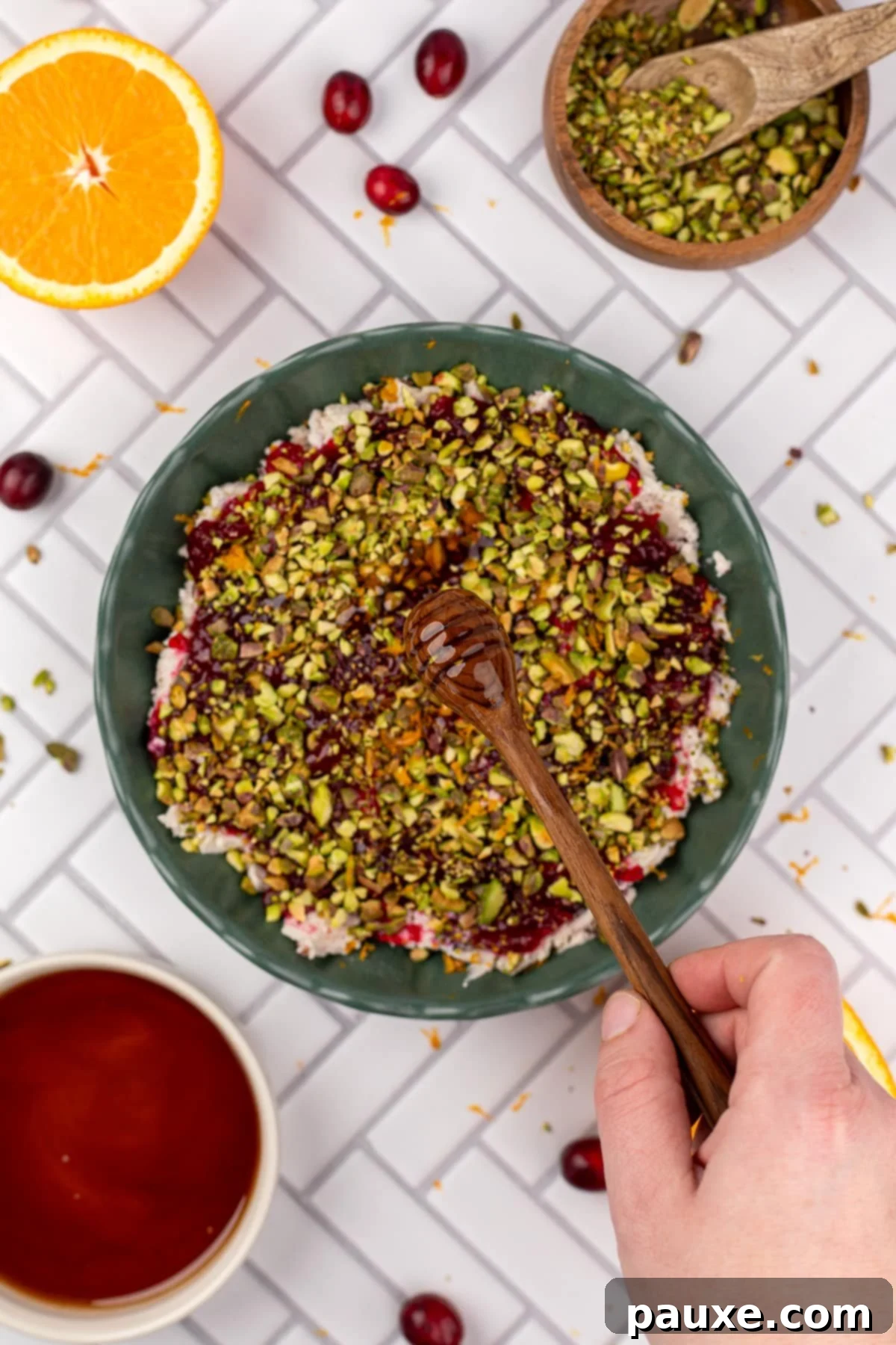 Drizzling hot honey over the assembled dip