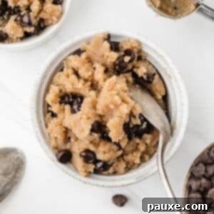Safe-to-Eat Cookie Dough 9 A small bowl of cookie dough filled with chocolate chips, and a spoon sticking out of the side.