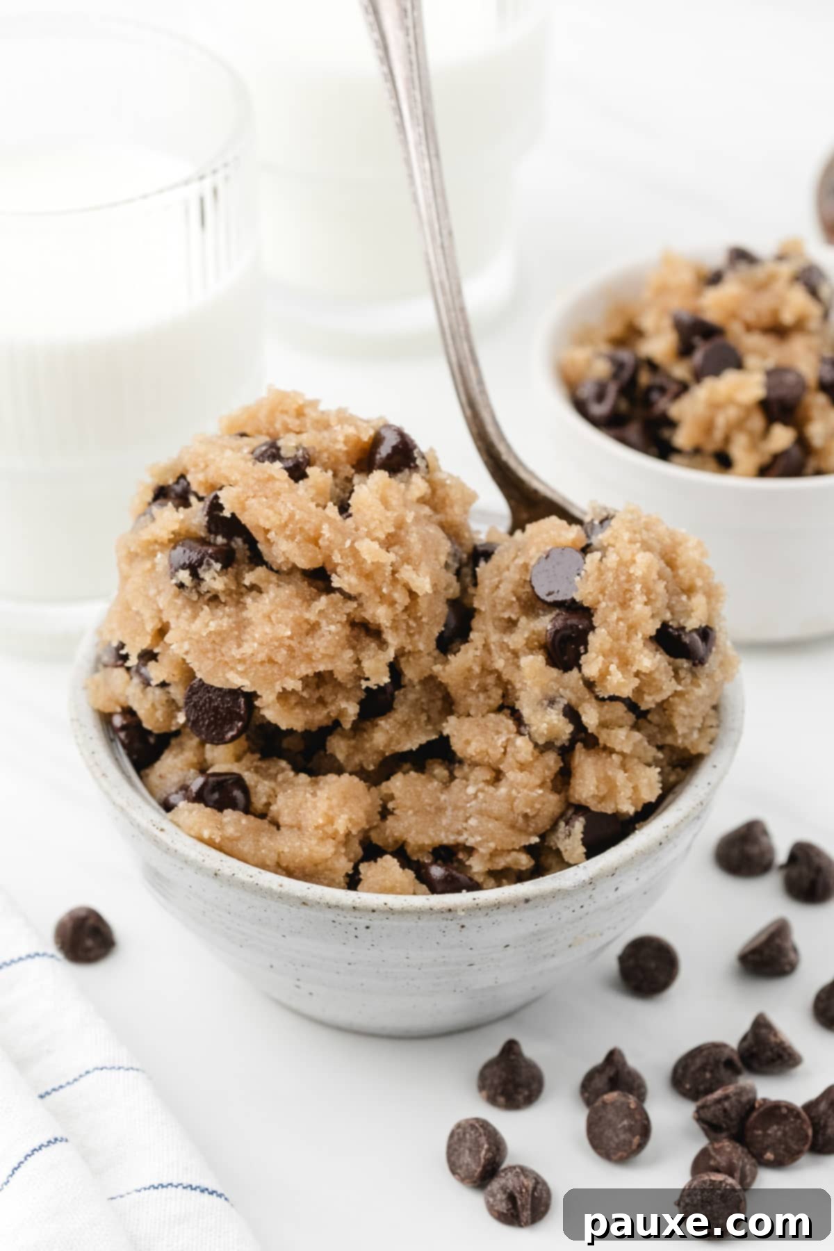 Safe-to-Eat Cookie Dough 5 A bowl of chocolate chip cookie dough with a spoon sticking out of it.