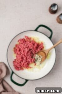 Taco Mac 'n' Cheese Explosion 9 Ground beef in a skillet with onion and garlic.