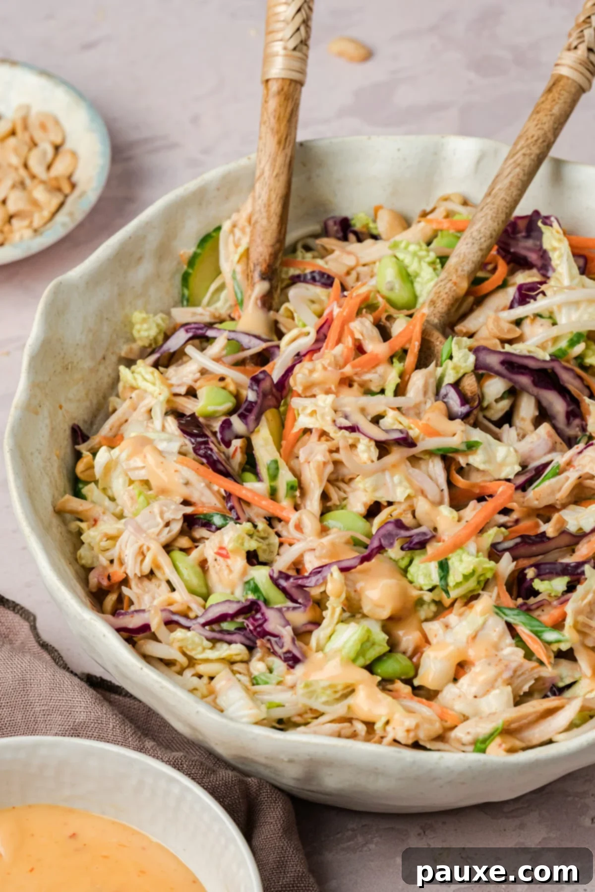 Bang Bang Chicken Salad: A Flavor Explosion 2 A delicious Bang Bang Chicken Salad being tossed in a bowl.