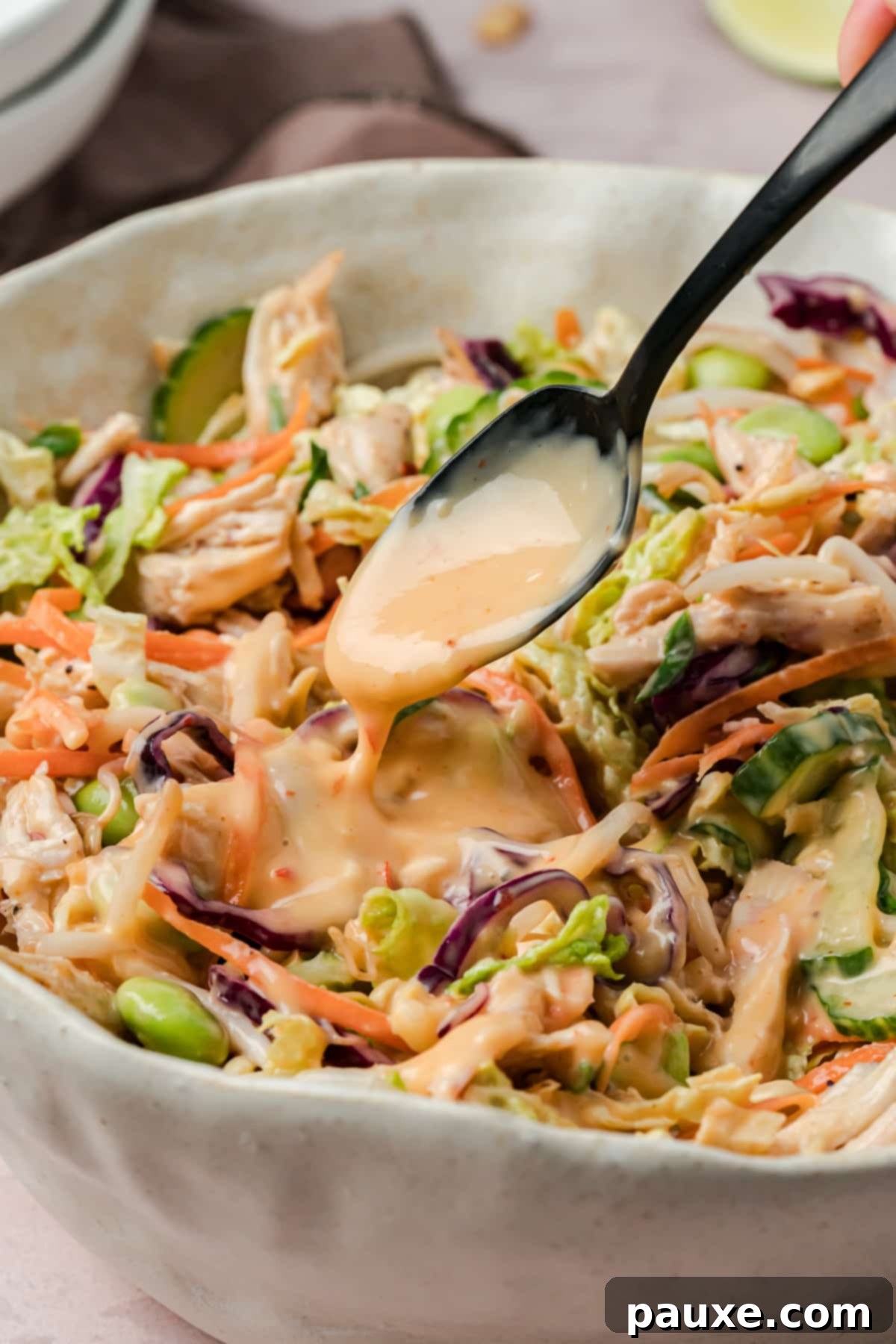 Bang Bang Chicken Salad: A Flavor Explosion 6 Drizzling bang bang sauce over the chicken and cabbage salad.
