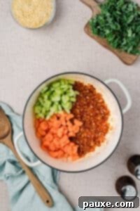Vegetarian Orzo Delight 9 Adding celery and carrots to a Dutch oven
