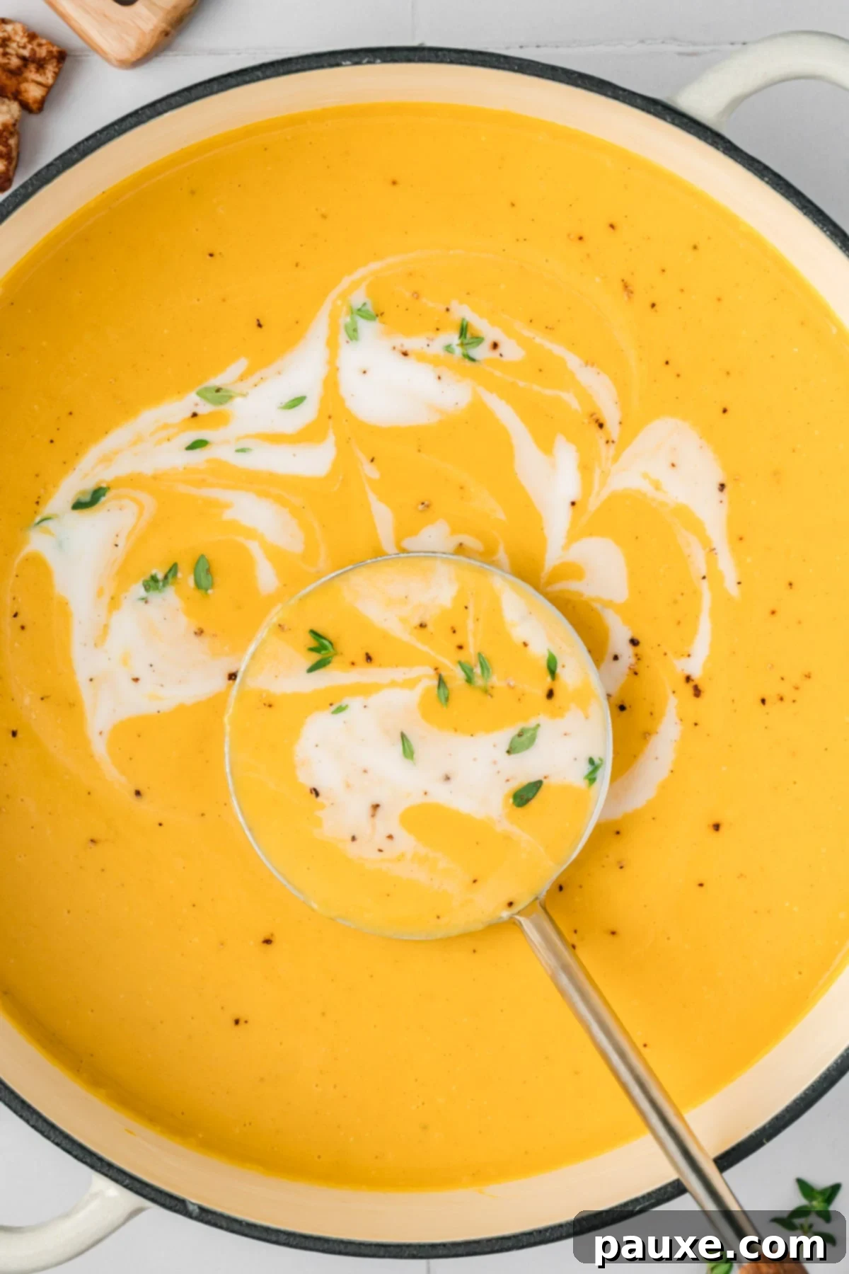 Creamy Autumn Harvest Soup 7 Butternut squash soup in a Dutch oven with a swirl of coconut milk
