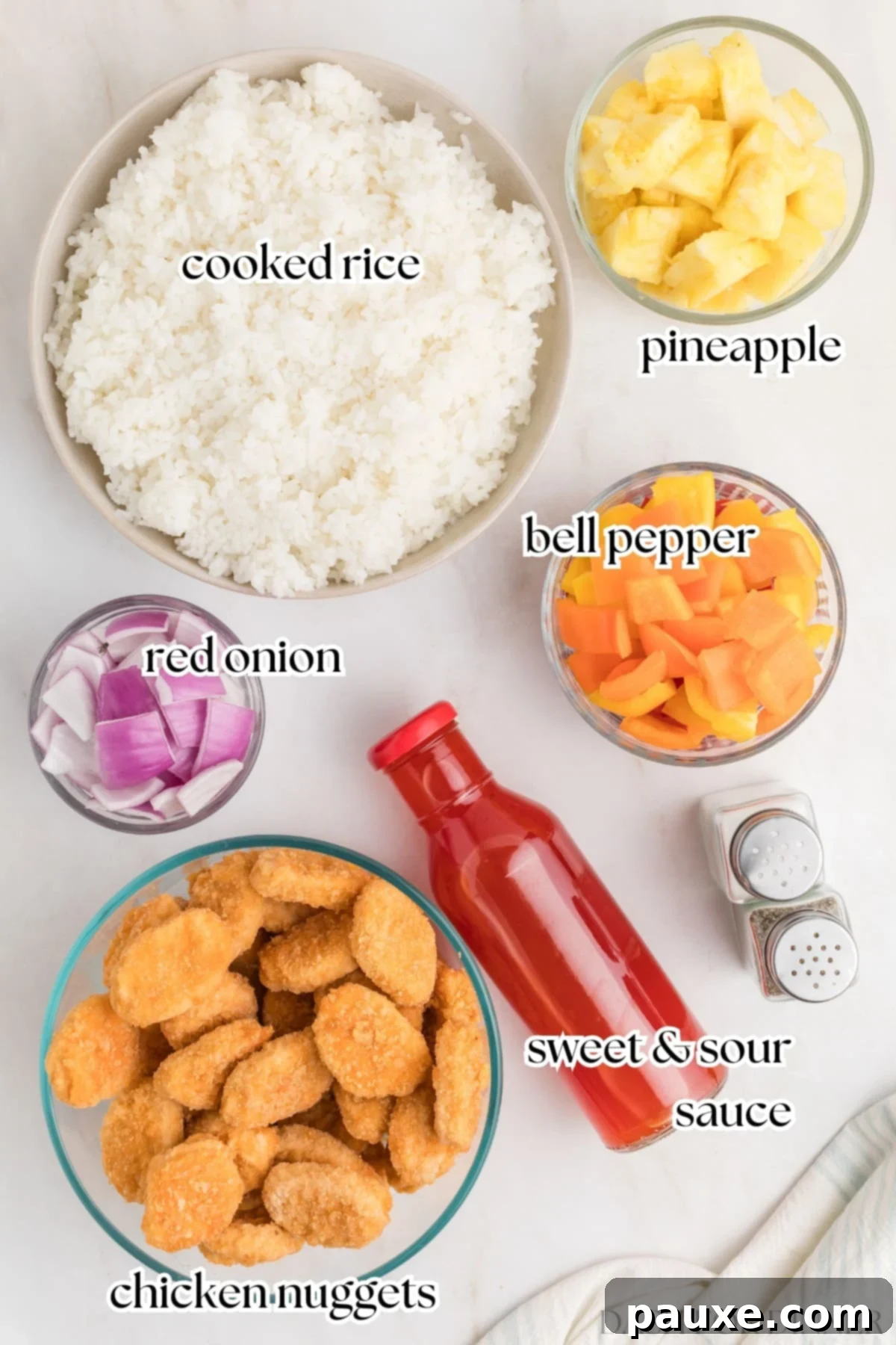 Ingredients for easy sweet and sour chicken, including chicken nuggets, rice, and pineapple.